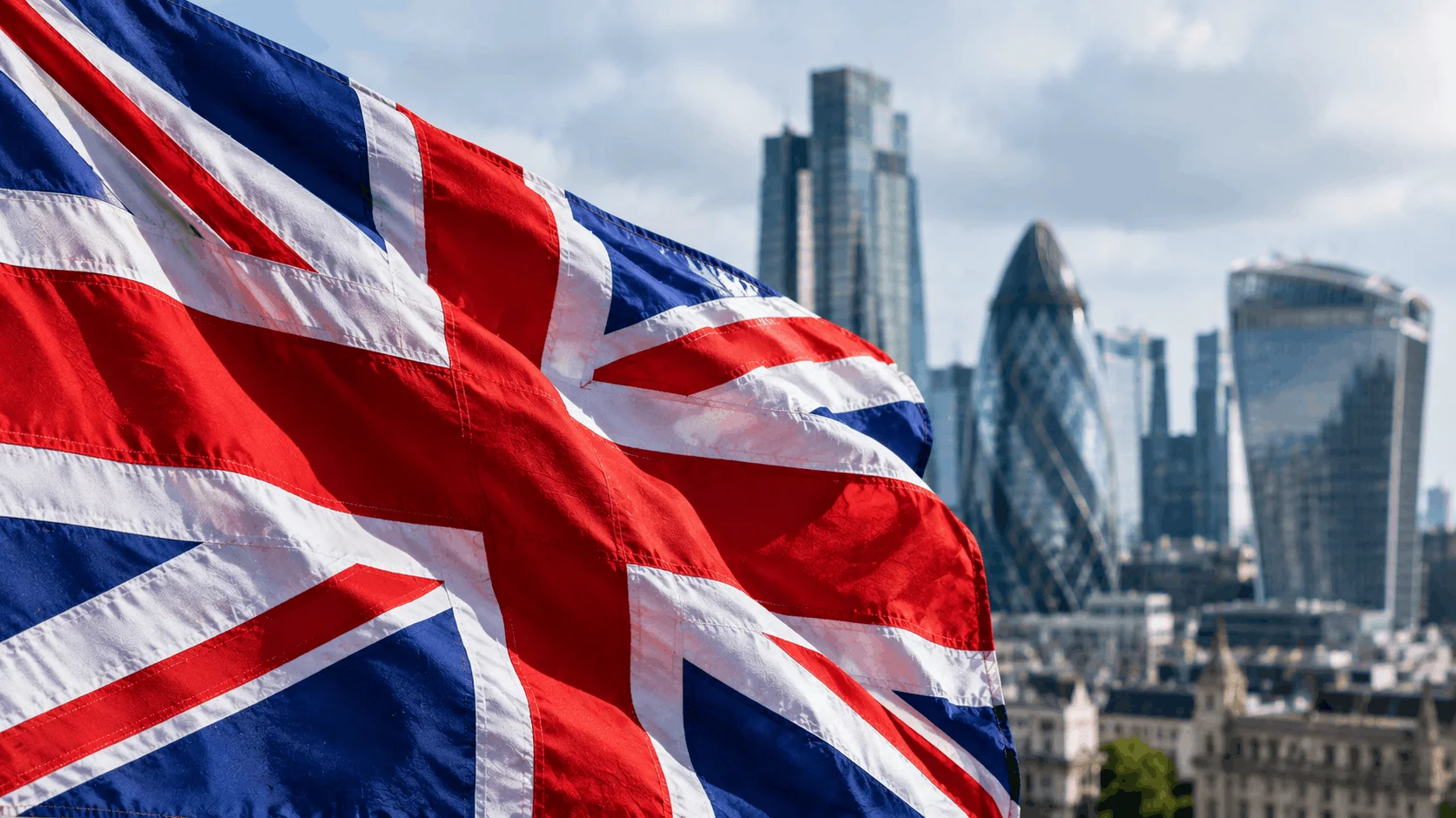 Close-up of the British flag with the London financial district in the background