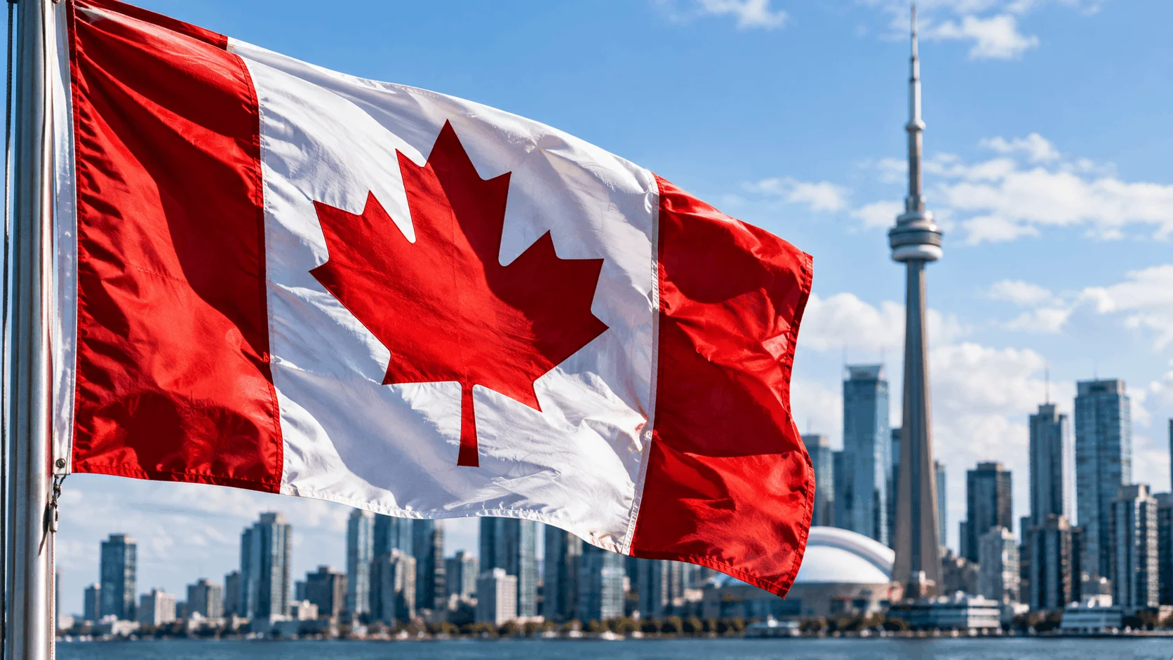 Close-up of the Canadian flag with the city of Toronto in the background