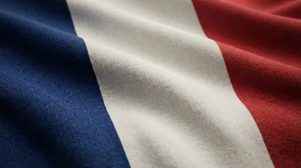 Close-up of the French national flag with blue, white, and red stripes and realistic flowing fabric.