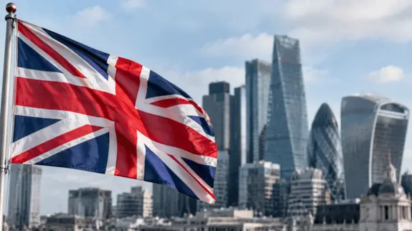 Close-up of the British flag with the London financial district in the background